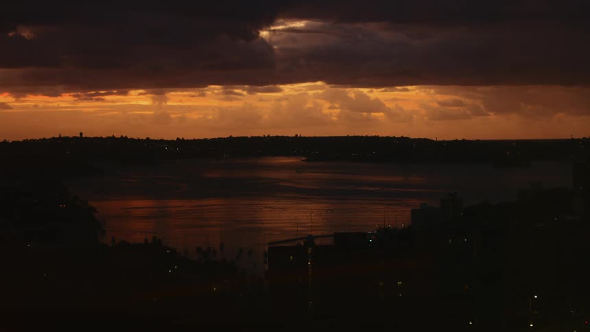 The sun is setting on the shore