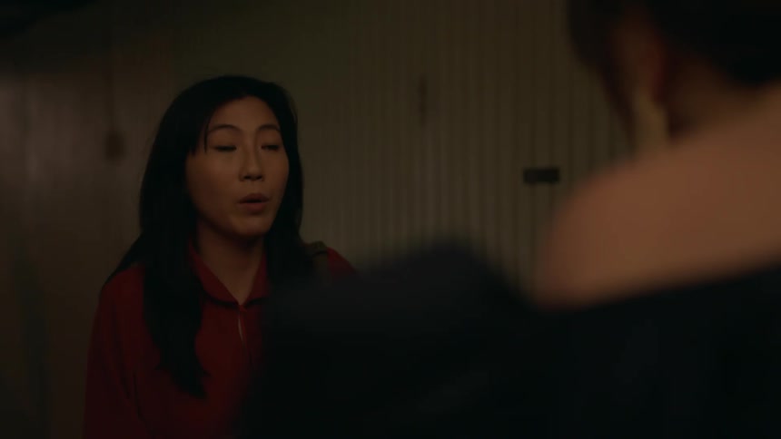 Woman holding a drink opens the door for a happy nervous woman