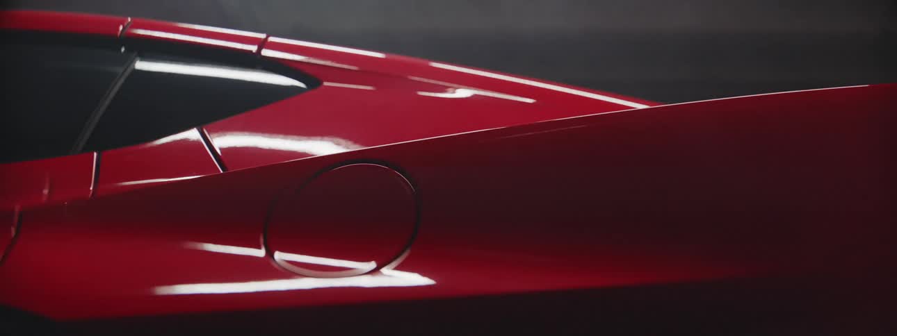A red vehicle is on display during the night time