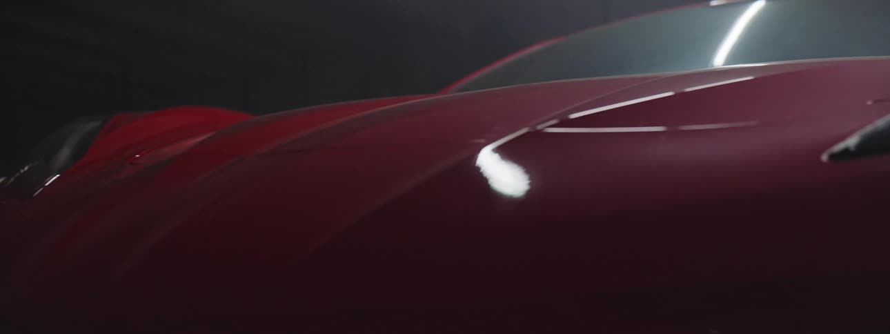 Specular highlights and shadows on a red sports car