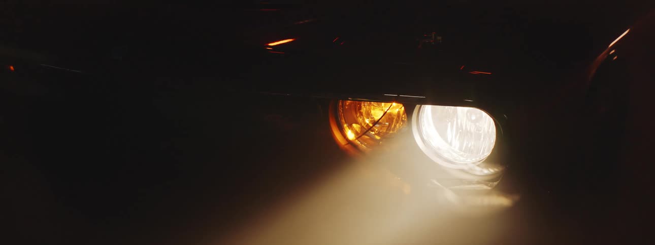 Close up view of a headlight on a parked car