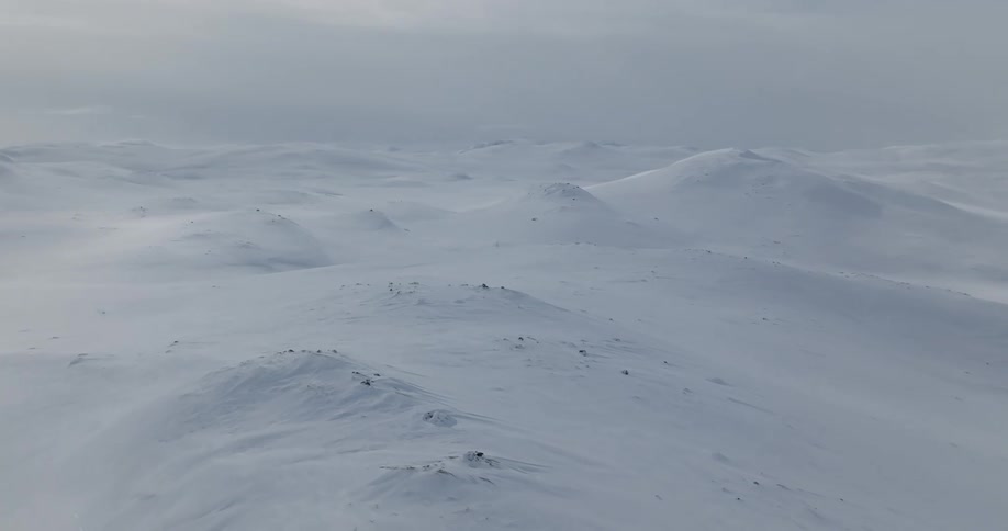 Aerial view of mountains during winter is displayed