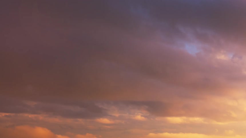A time lapse of clouds rolling across the sky as the skies change from daylight to dusk