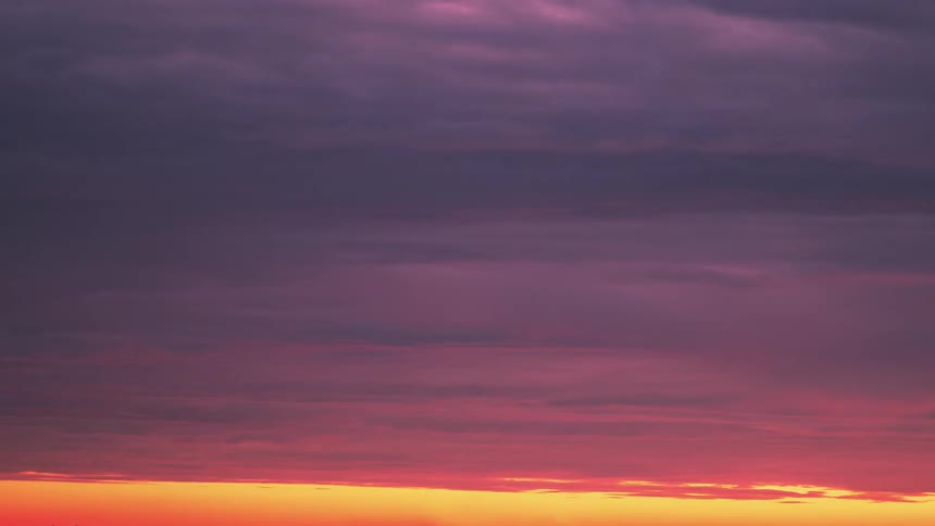 Clouds move through the sky as the sun sets