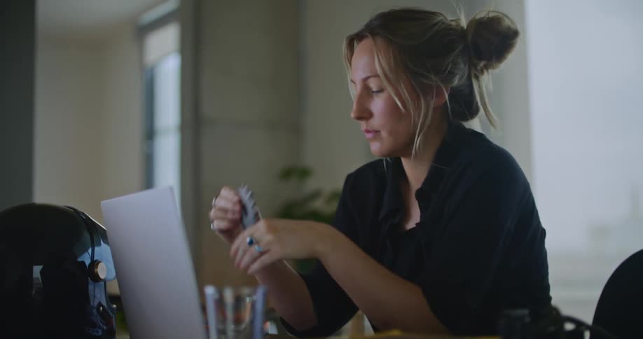 A young woman is sitting down and using her a computer