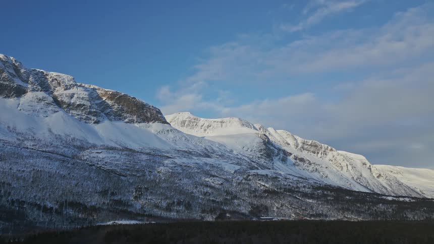 A mountain range during winter is displayed