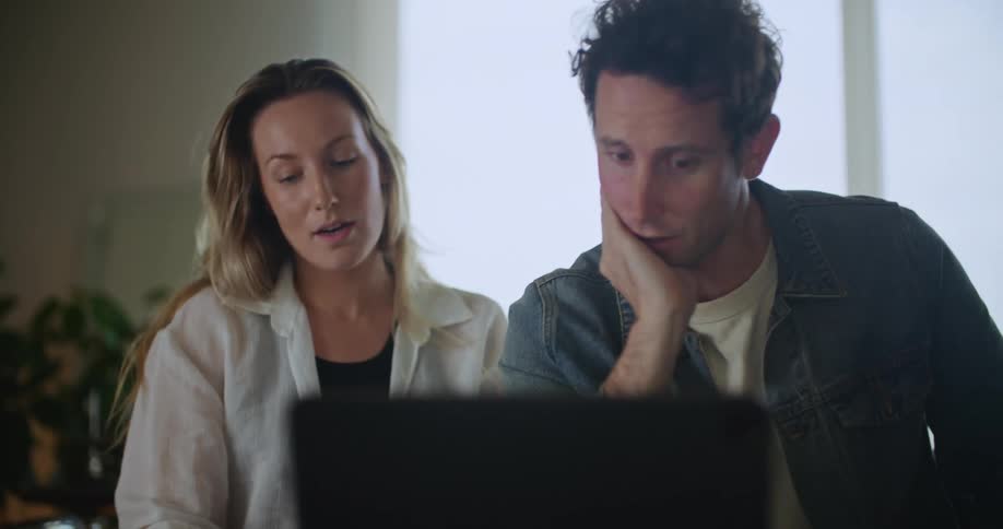 Young couple is indoors and is using the computer