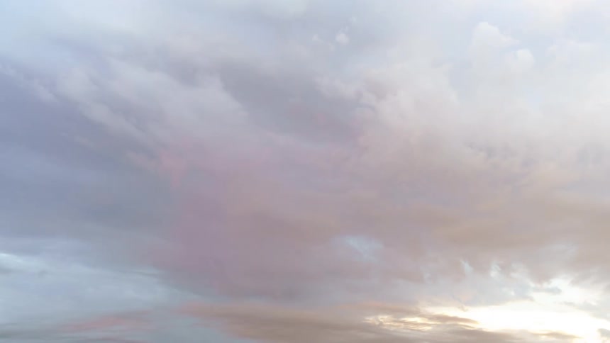 Cumulus clouds move as they float across a blue sky