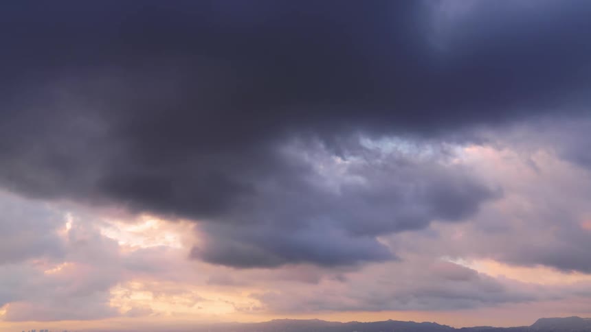 Clouds moving in the sky during sunset