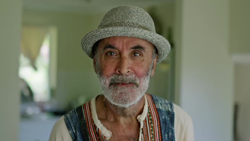 Portrait of a man smiling and wearing a hat