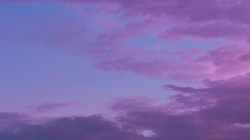 Clouds pass through the sky as the sun sets