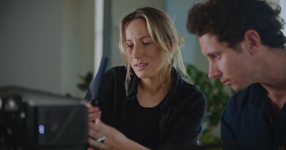 Two people are indoors and having a conversation