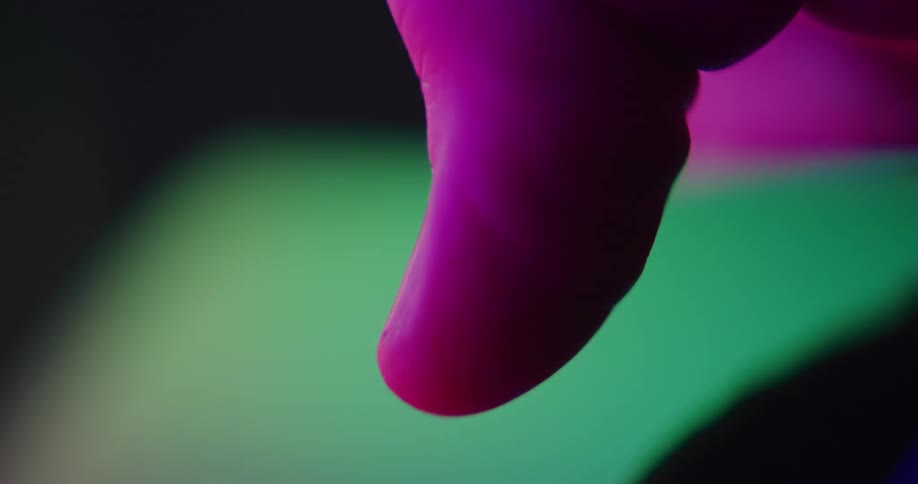 An extreme close up of a persons thumb bent and pressing down