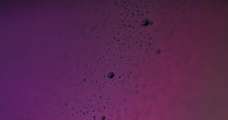 Droplets on a surface under shifting colorful lights