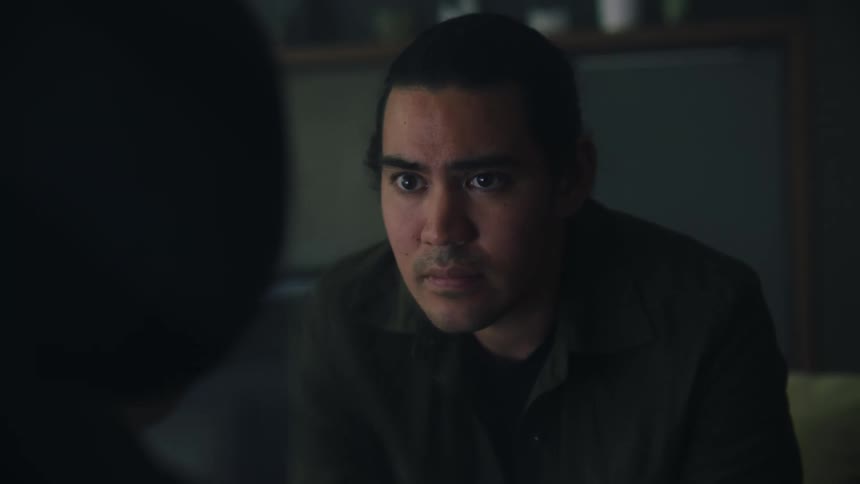 The view is of a young man that looks sad as he is sitting down