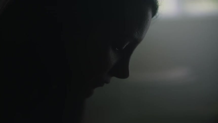 Side profile of woman looking down and thinking