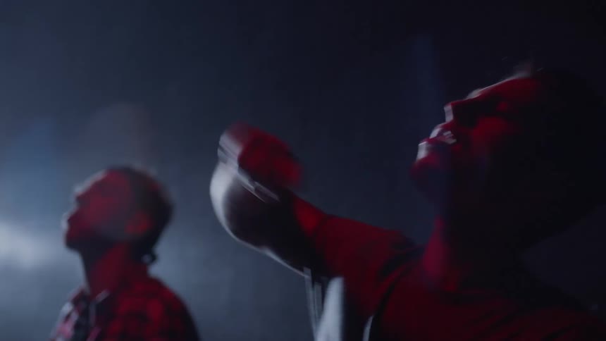 Two djs perform on stage