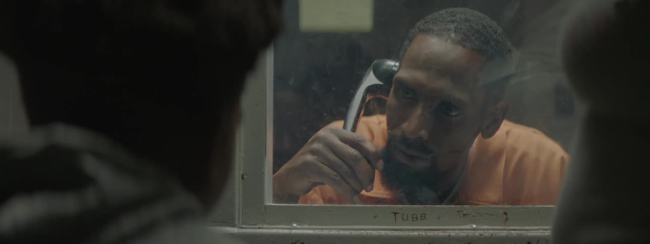 A man in prison talks to another man