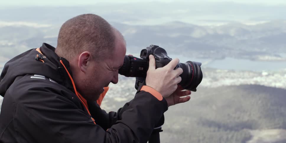 A man takes some photographs high up