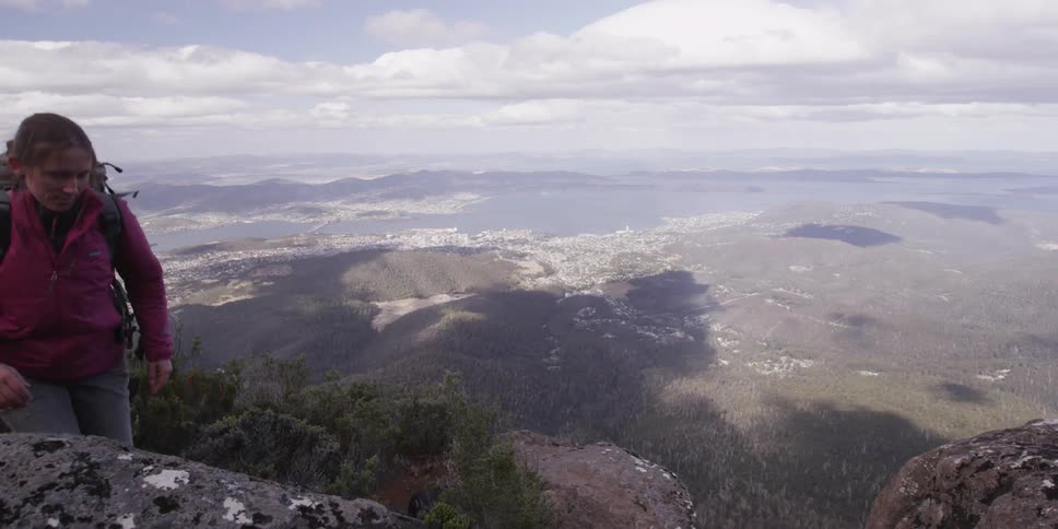 Hiker climbing a tall mountain