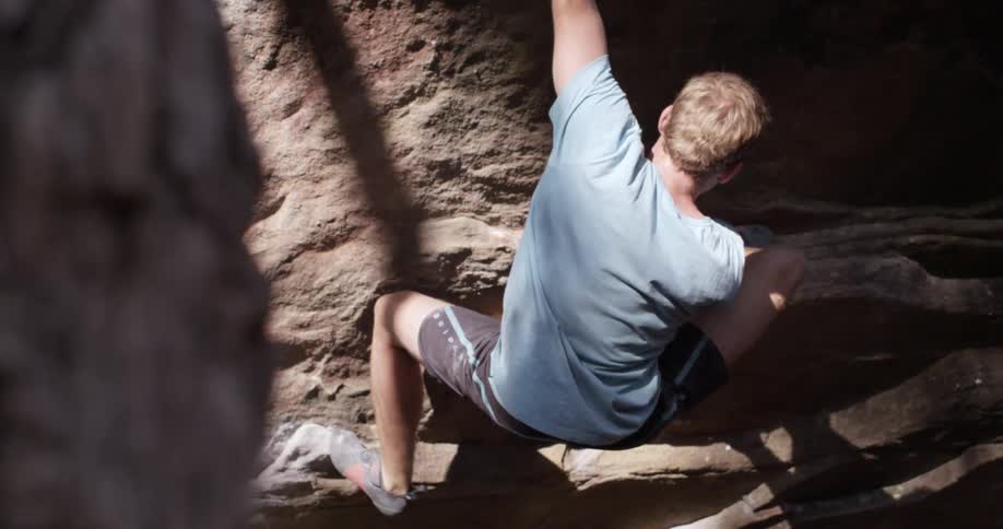 A man is climbing a rock cliff