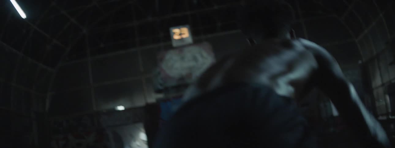 A man dribbles a ball indoors