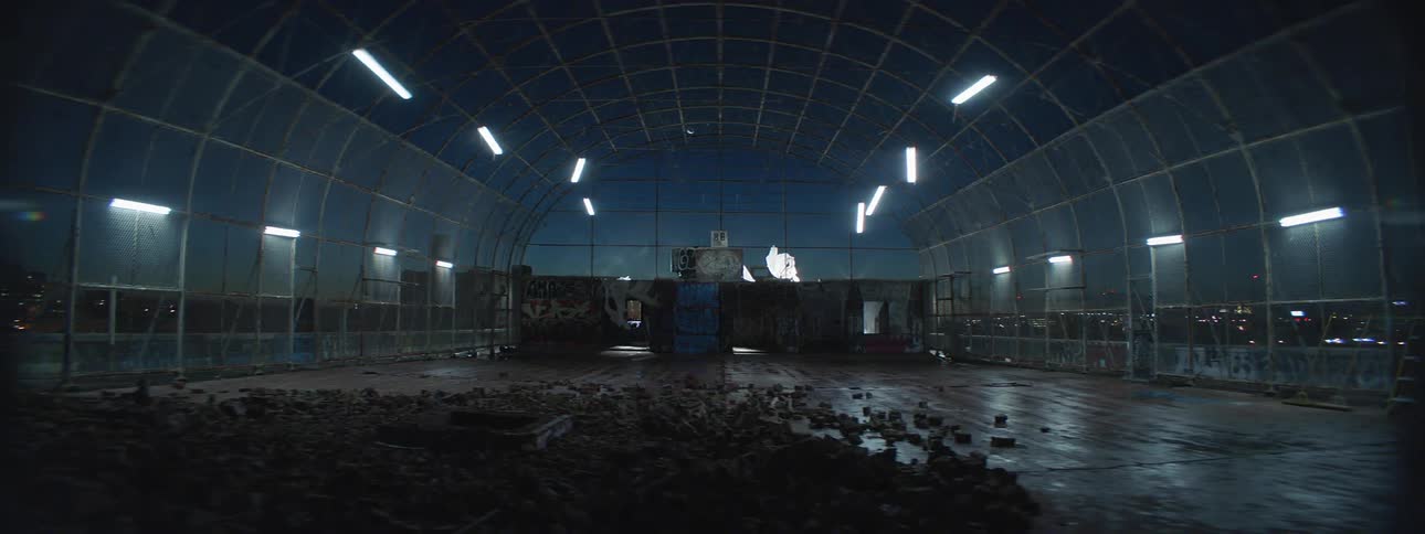 A room with lights swaying and dirt on the ground