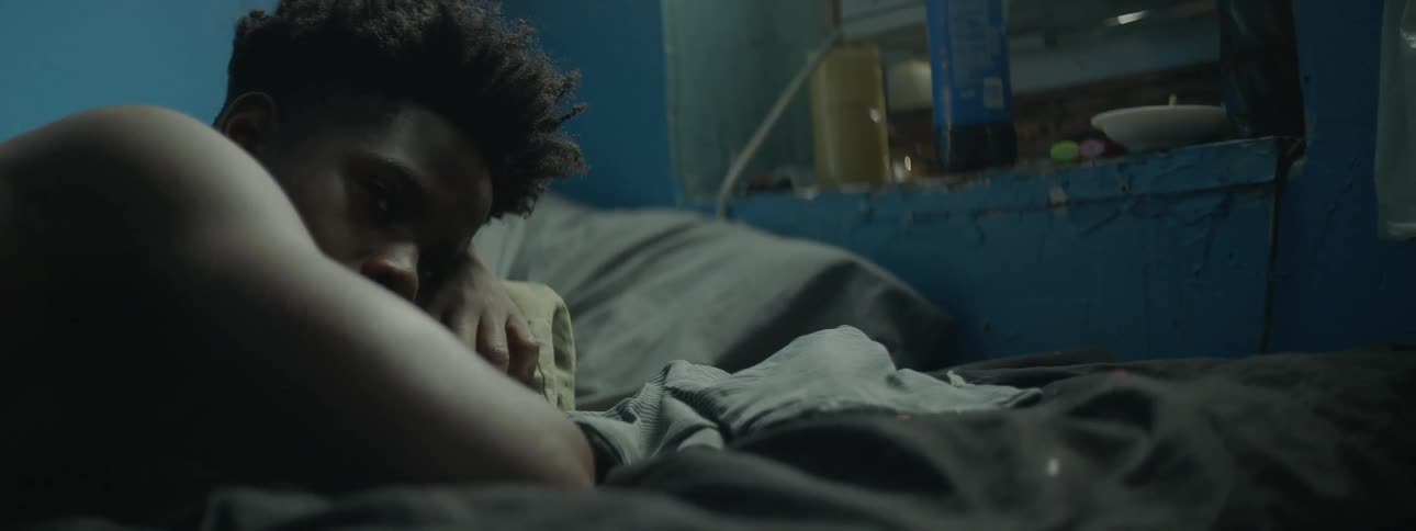 A boy lies in a bed