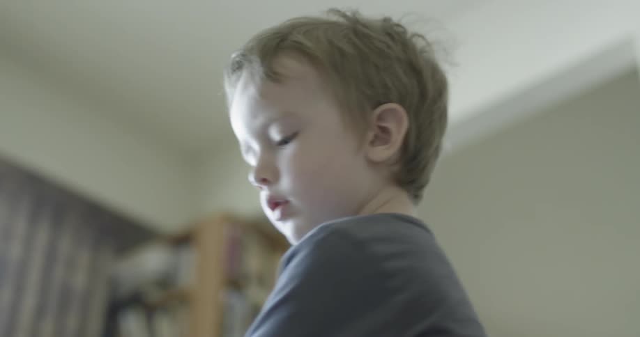 A boy removes a sticker from a sheet