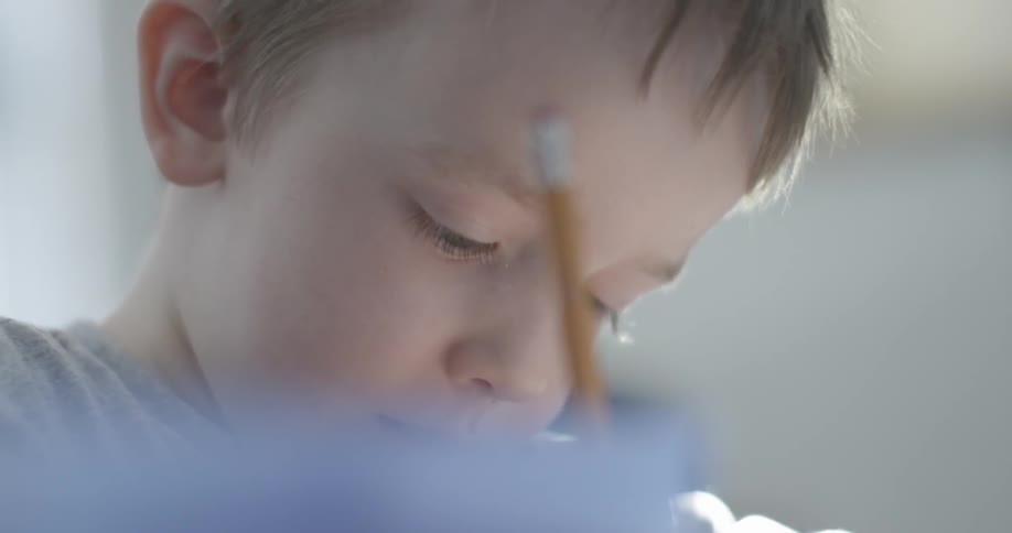 Young person writing with a pencil