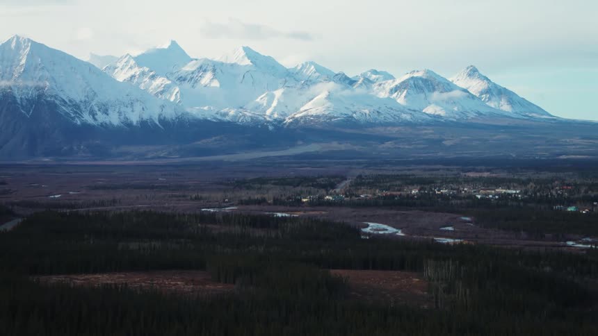 Aerial view of small town and distant snowy mountain range