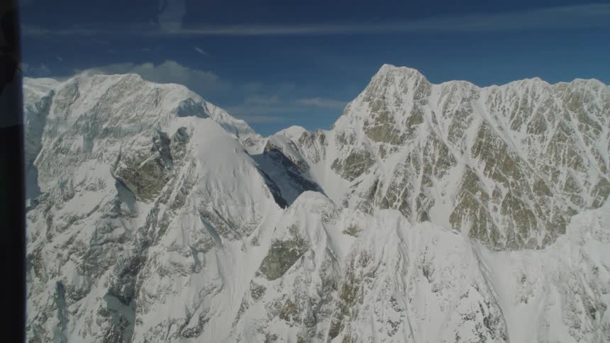 Aerial view of snowy mountain range with rugged peaks