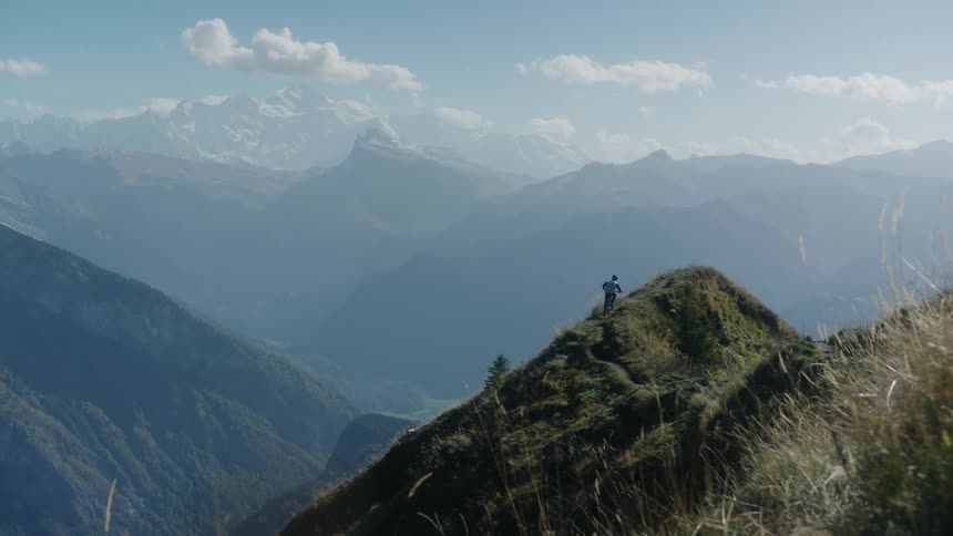 A person is dirt biking across a mountainous landscape