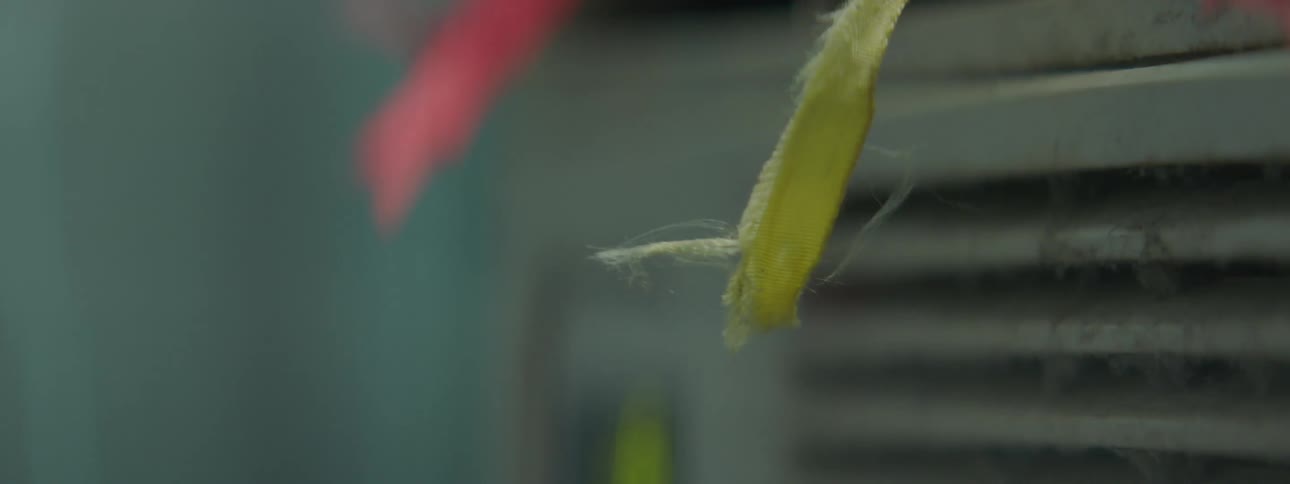 Small ribbons sway on an air conditioner