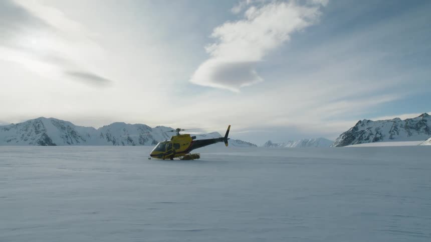 A man is moving by the running helicopter
