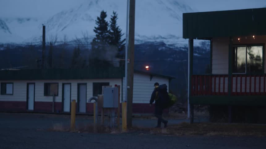 A man is leaving the motel