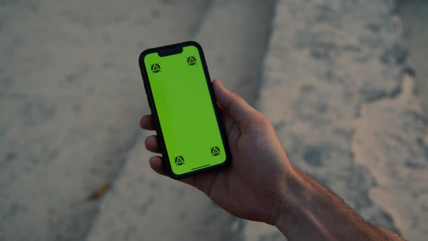 A persons hand and cell phone screen as they scroll through it