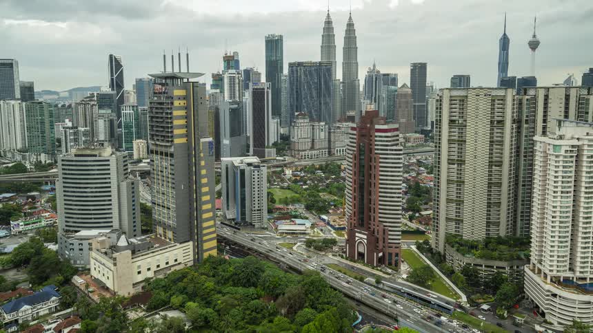 Intense traffic runs on the freeway through the city of Kuala Lumpur