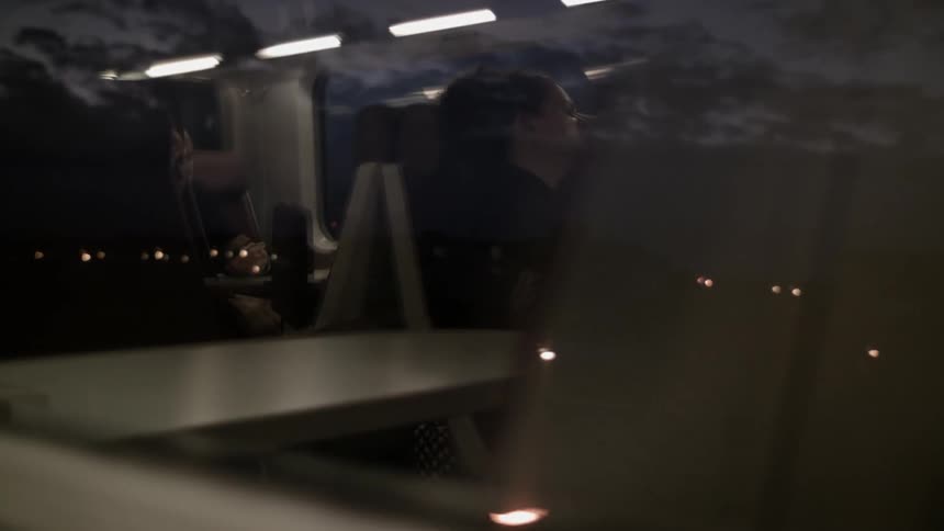 A woman rides on a train