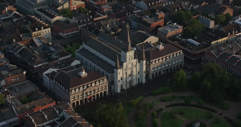 An aerial view of the iconic St Louis Cathedral and Jackson Square at sunrise in New Orleans Louisiana surrounded by historical buildings and city parks