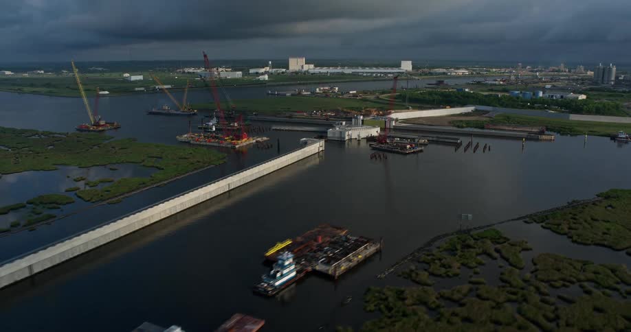 Sunrise aerial footage of a surge barrier and gate in a St Bernard Parish Bayou amidst wetlands and marshland in Louisiana