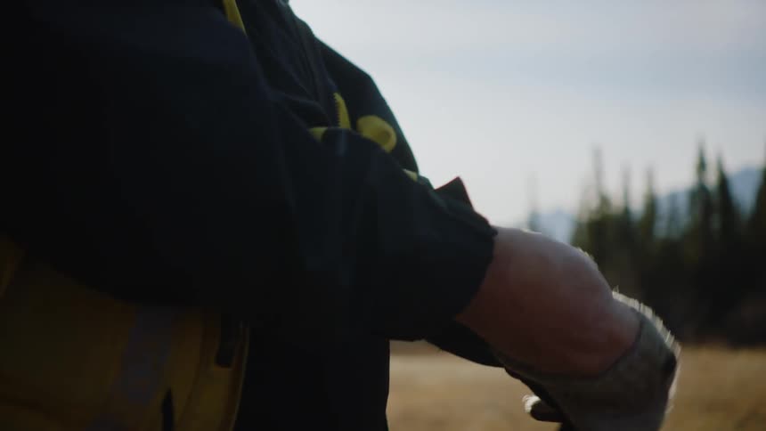 A man puts on gloves