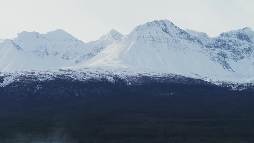 A vast mountain range wilderness covered in snow
