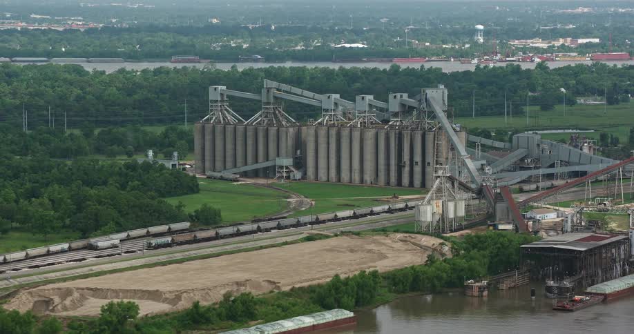 An aerial view of factory silos on the Mississippi River waterfront in New Orleans during a partly cloudy day