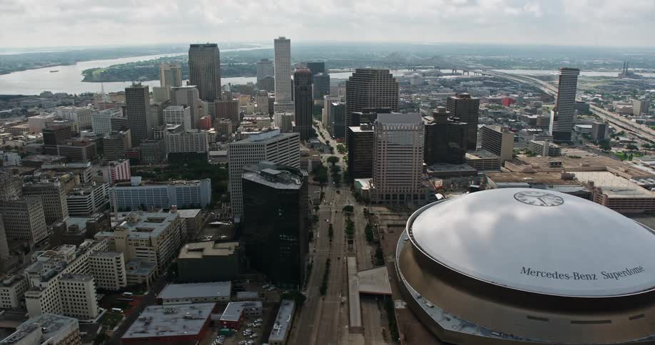 A stunning 4K aerial video of Downtown New Orleans including the Superdome and skyscrapers shot during a partly cloudy day in the summertime