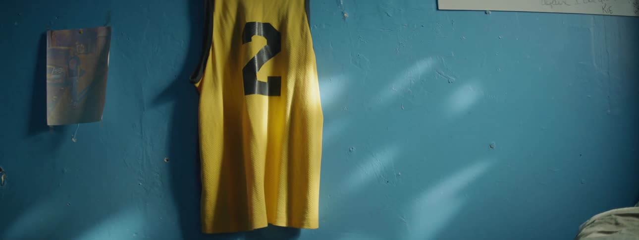 A jersey hangs on a blue wall