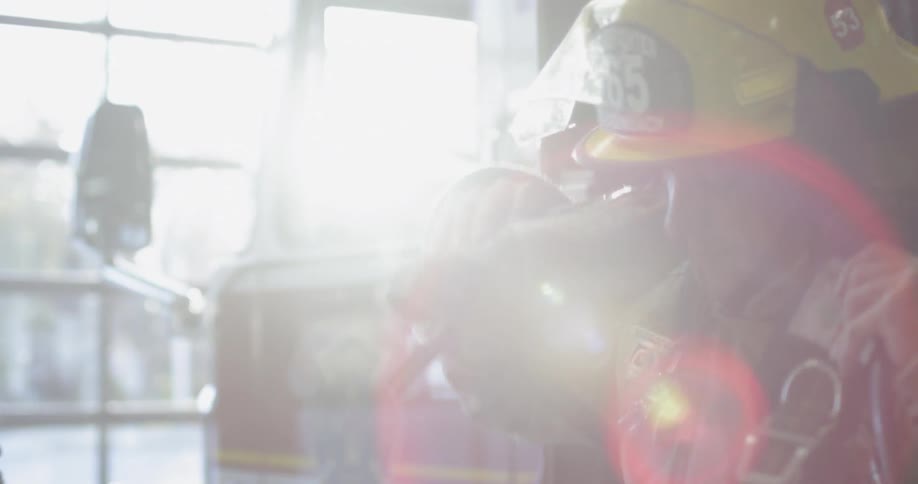 A firefighter is gearing up