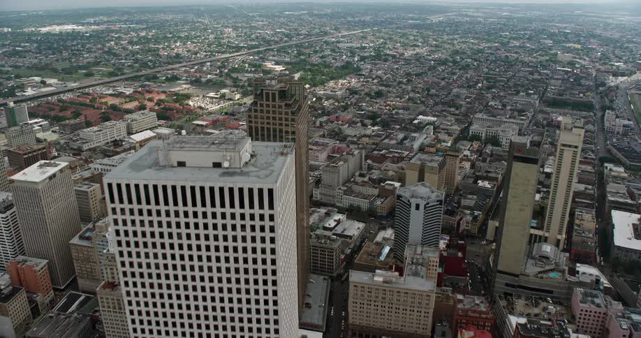 A breathtaking 4K aerial clip of Downtown New Orleans with towering skyscrapers as it flies over towards the iconic French Quarter