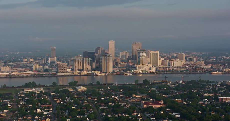 Aerial view of Downtown New Orleans skyline and the Mississippi River during sunrise seen from across the river during summer