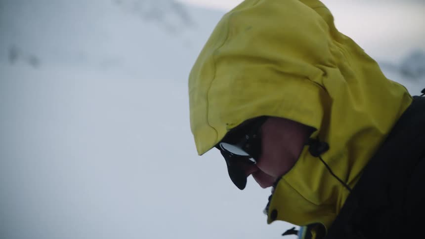 A man is hiking through the wilderness during winter